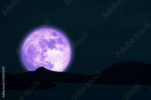 Full Snow Moon on night sky back silhouette island in the ocean night sky
