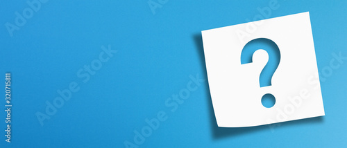 Note paper with question mark on panoramic blue background photo