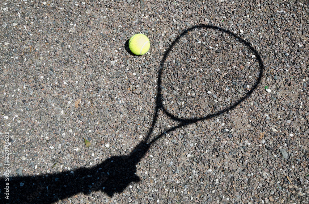 Shadow Playing Tennis with Racket and ball on the Gravel.