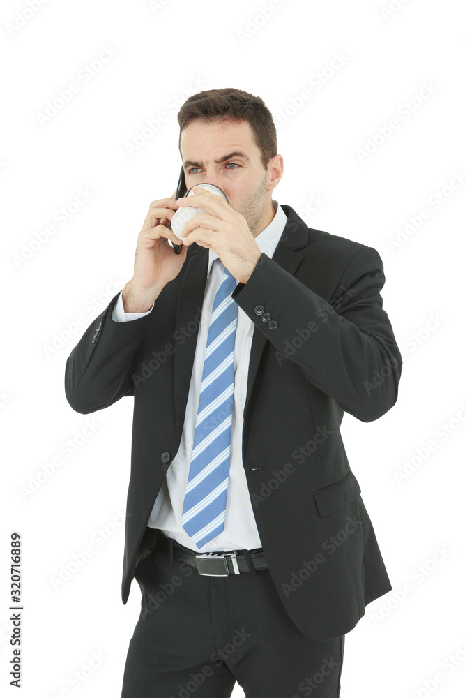 Smart businessman in suit talking on smartphone and drinking hot coffee isolated on white background Smart businessman in suit talking on smartphone and drinking hot coffee isolated on white background