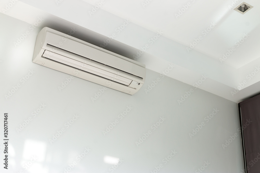 Air conditioning Installed on a white concrete wall in the house. Air conditioning Installed on a white concrete wall in the house.