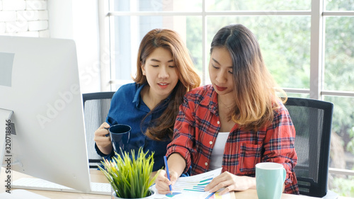 Photography Asian women at home office, Happy two young asian women working with laptop com
