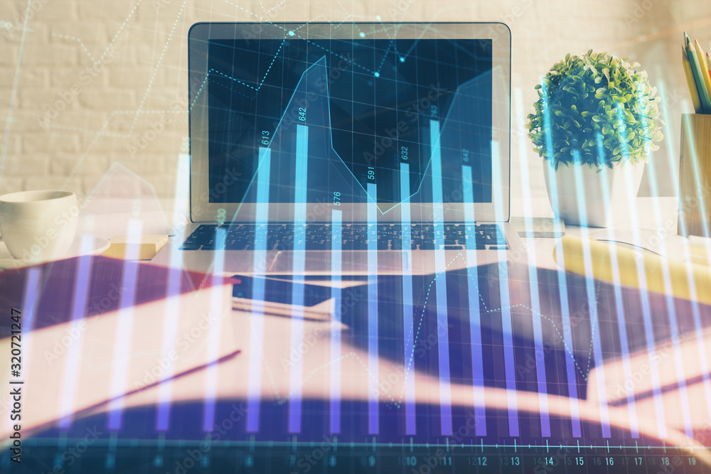Stock market chart hologram drawn on personal computer background. Multi exposure. Concept of investment. Stock market chart hologram drawn on personal computer background. Multi exposure. Concept of investment.