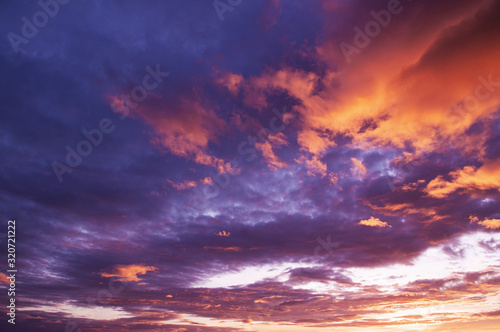 Beautiful red vibrant burning sunset sky with clouds