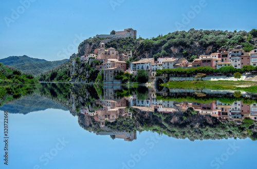Reflections in the Ebro of the town of Miravet in Tarragona
