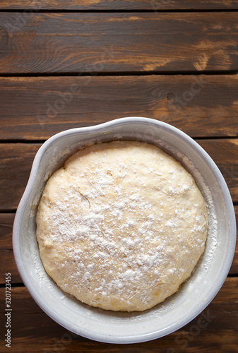 yeast dough on dark wooden surface