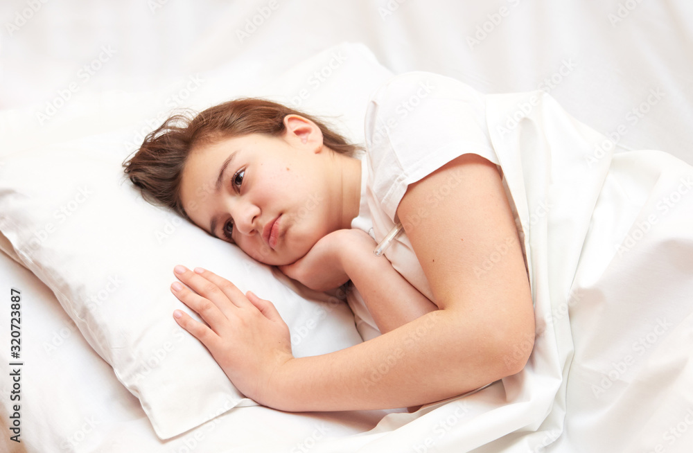 sick girl lying in white bed with a thermometer. . coronavirus sick girl lying in white bed with a thermometer. . coronavirus