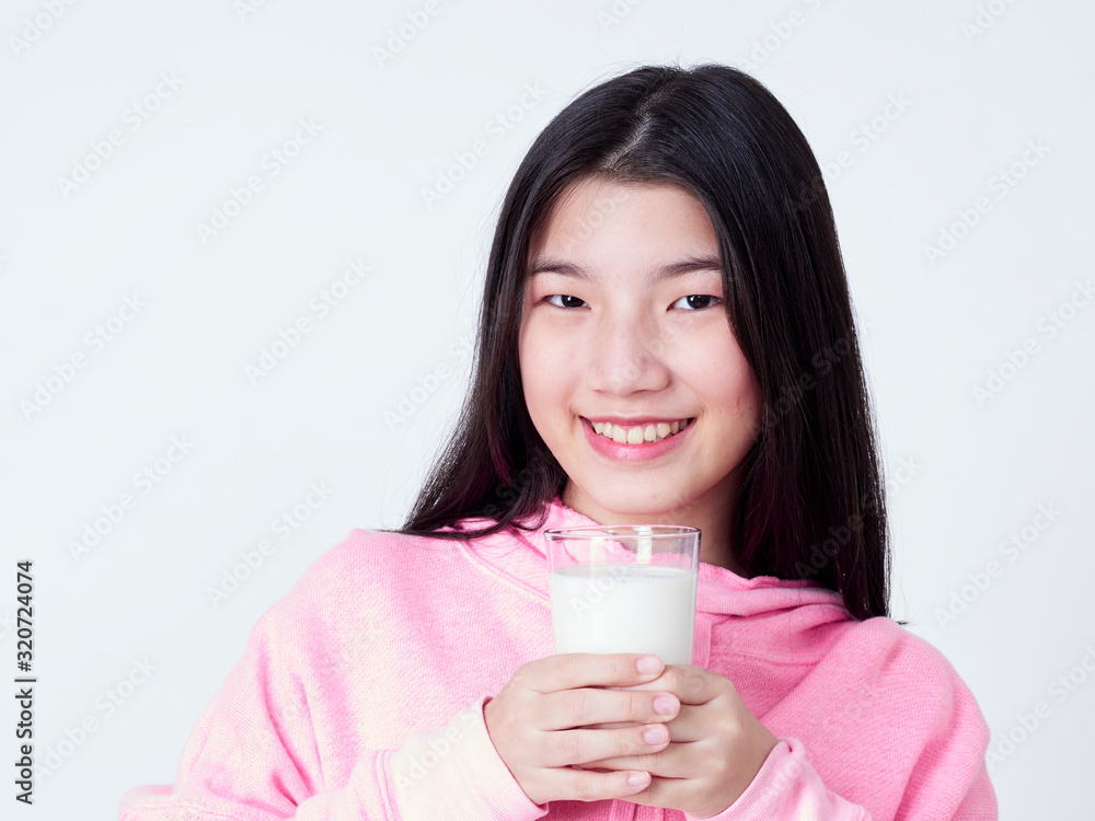 Teenage girls holding a glass of milk. Teenage girls holding a glass of milk.