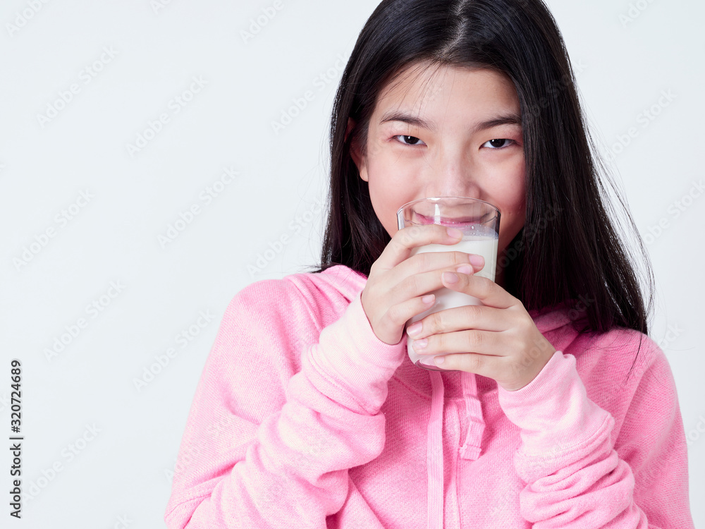 Cheerful girl drinking milk fresh.