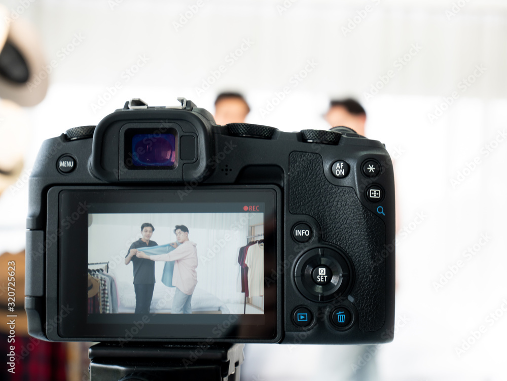 Asian influencer blogger couple young man live selling fashion shirt clothing and record camera closeup scene for upload content in channel for promote e-commerce marketing share on social network Asian influencer blogger couple young man live selling fashion shirt clothing and record camera closeup scene for upload content in channel for promote e-commerce marketing share on social network