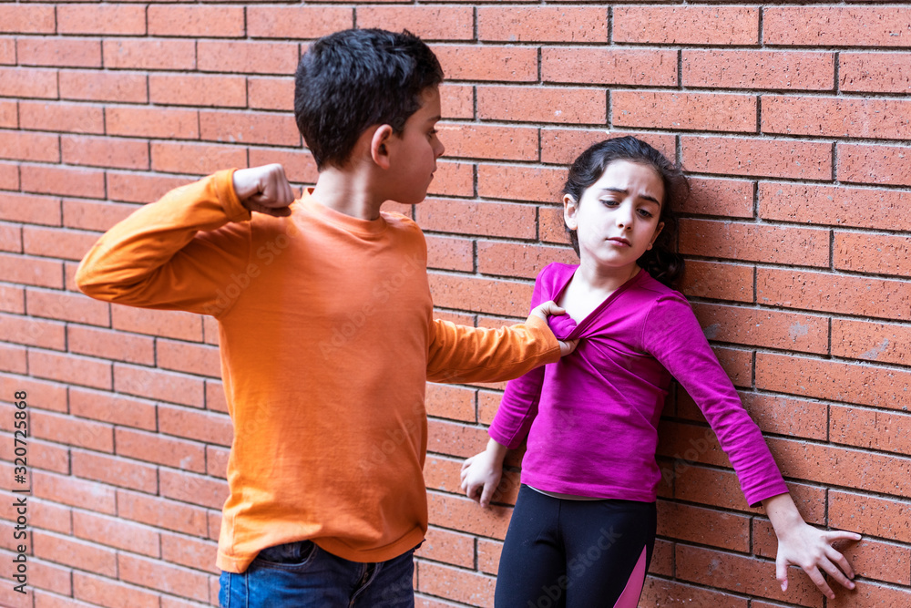 Little kid hitting another on the school. Bullying concept Little kid hitting another on the school. Bullying concept