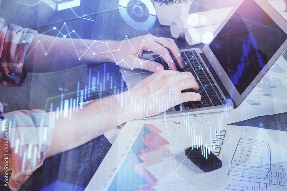 Double exposure of stock graph with businessman typing on computer in office on background. Concept of hard work. Double exposure of stock graph with businessman typing on computer in office on background. Concept of hard work.