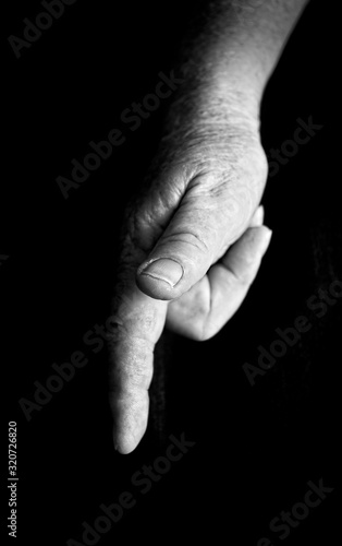 Mature aged hand pointing downwards