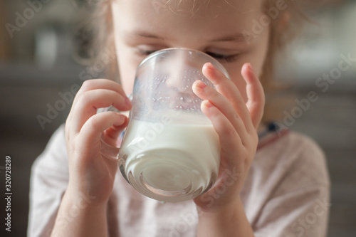 Portrait of a child with a cup of milk