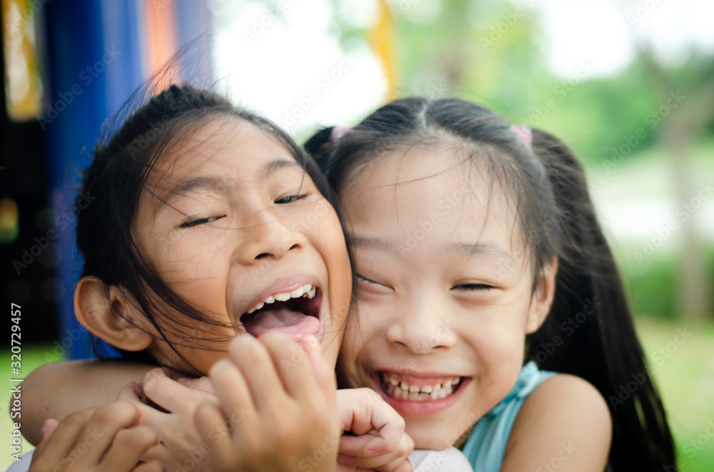 happy children embracing each other and smiling at camera happy children embracing each other and smiling at camera