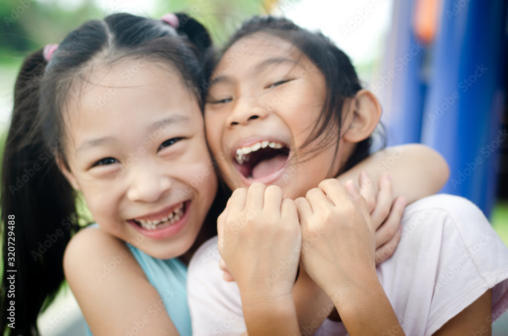 happy children embracing each other and smiling at camera, motion blur. happy children embracing each other and smiling at camera, motion blur.