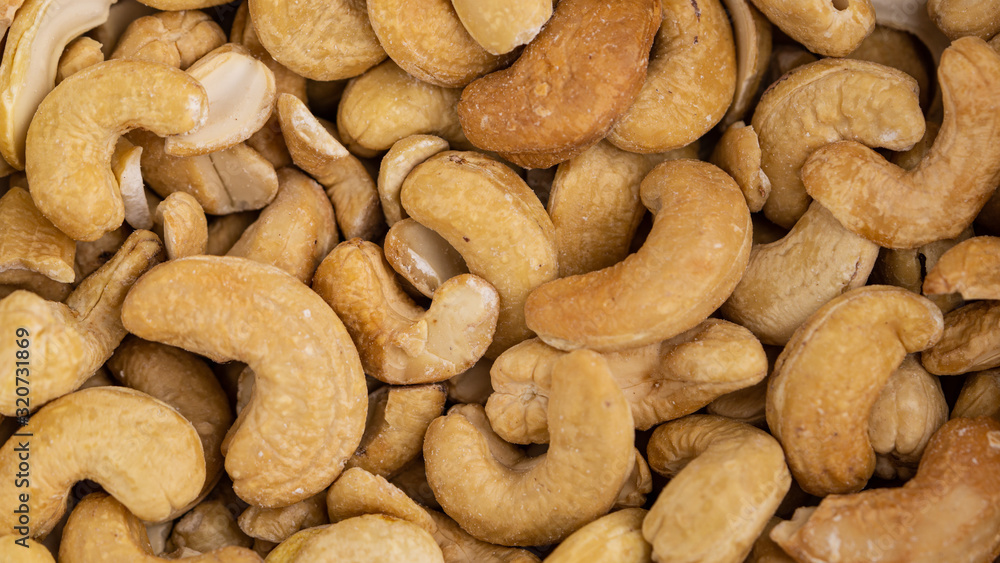 Fototapeta premium Roasted cashew nuts. Full frame macro photo.