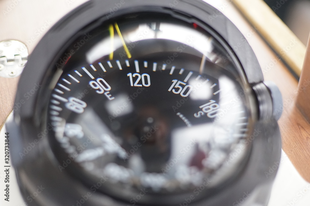 Close-up of ship compass on sailing boat Close-up of ship compass on sailing boat