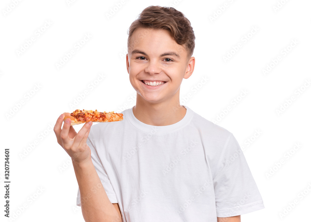 Happy handsome young teen boy holding slice of pizza. Close up portrait of smiling child with delicious Italian pizza, isolated on white background. Guy with fast food, looks at camera.