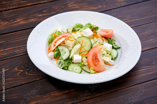 greek salad on the wooden background