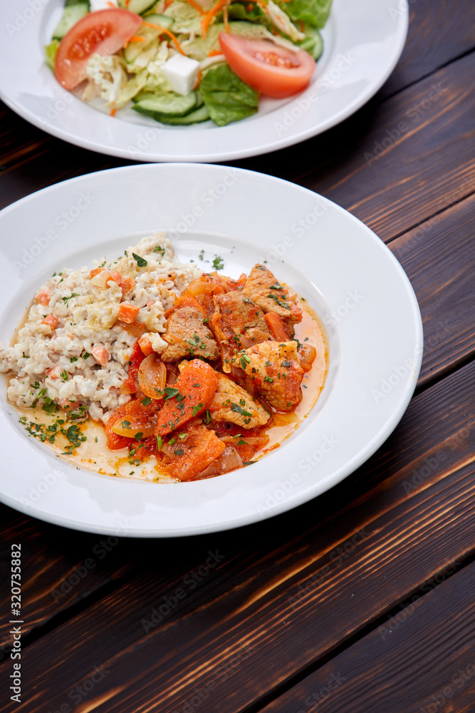 meat with barley and salad on the wooden background meat with barley and salad on the wooden background