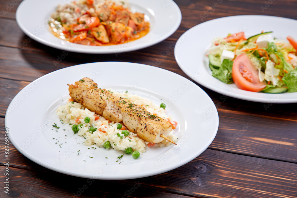 chicken kebab with rice and vegetables on the wooden background chicken kebab with rice and vegetables on the wooden background