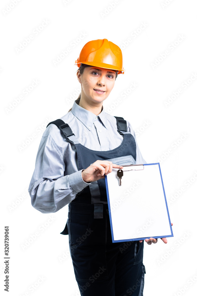 Smiling woman constructor with keys and empty copy space on a clipboard as a home sale concept. Isolated Smiling woman constructor with keys and empty copy space on a clipboard as a home sale concept. Isolated