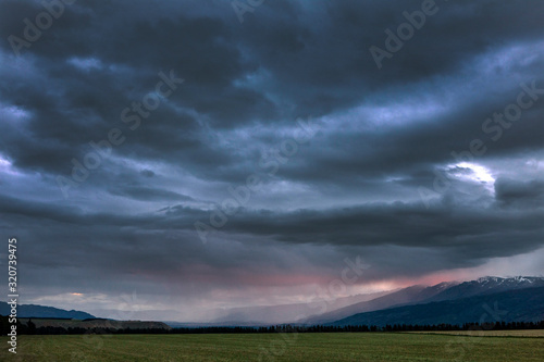 Tarras New Zealand. Thunder and rain clouds at twilight. Near Lindis Pass South Island. 