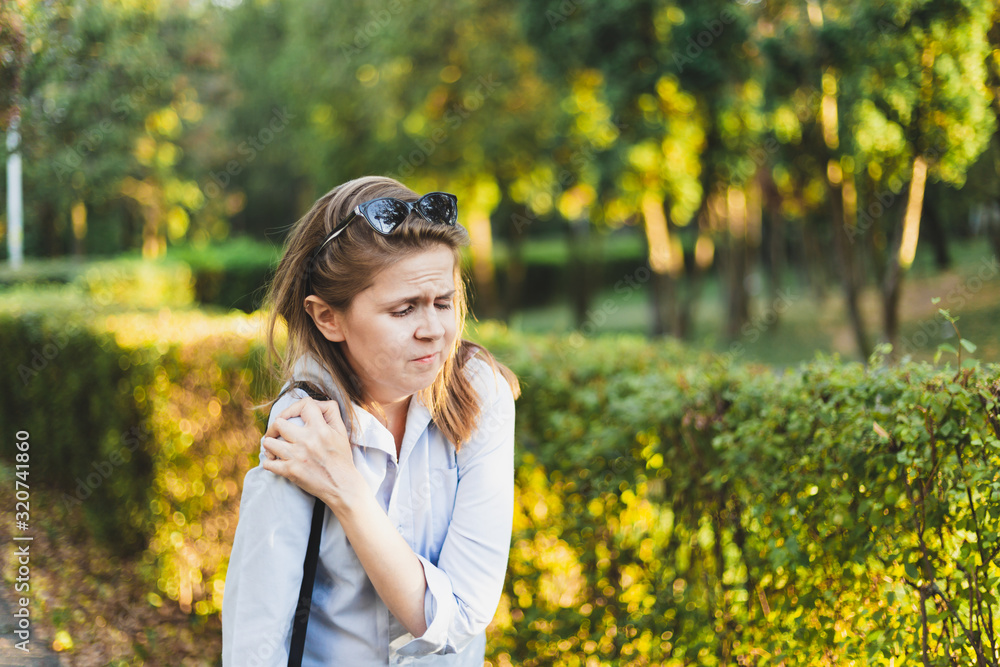 Tired and stressed female worker with arm cramps Tired and stressed female worker with arm cramps