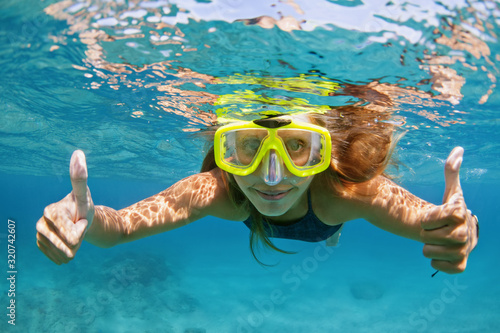 Happy family - active young woman in snorkeling mask dive underwater, see tropical fishes in coral reef sea pool. Travel adventure, swimming activity and watersports on summer beach cruise with kids.