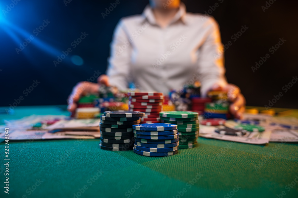 A player in a casino raises bets with chips, poker and a gaming business. The concept of a gaming business and online casino A player in a casino raises bets with chips, poker and a gaming business. The concept of a gaming business and online casino