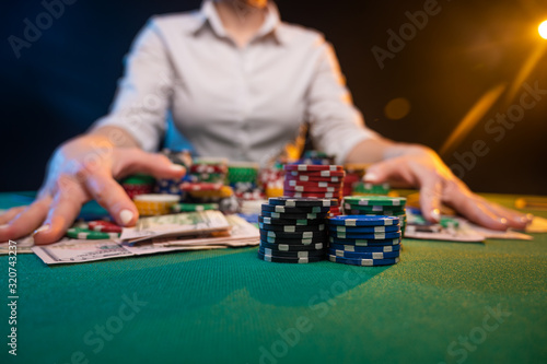 Playing in a casino, raising bets with chips, risk. Day and success. Excitement in poker and gaming business. Screensaver in an online casino.