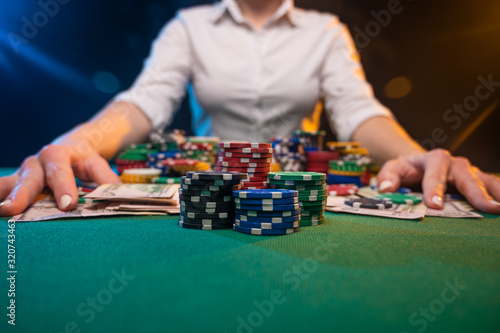 A player in a casino raises bets with chips, poker and a gaming business. The concept of a gaming business and online casino