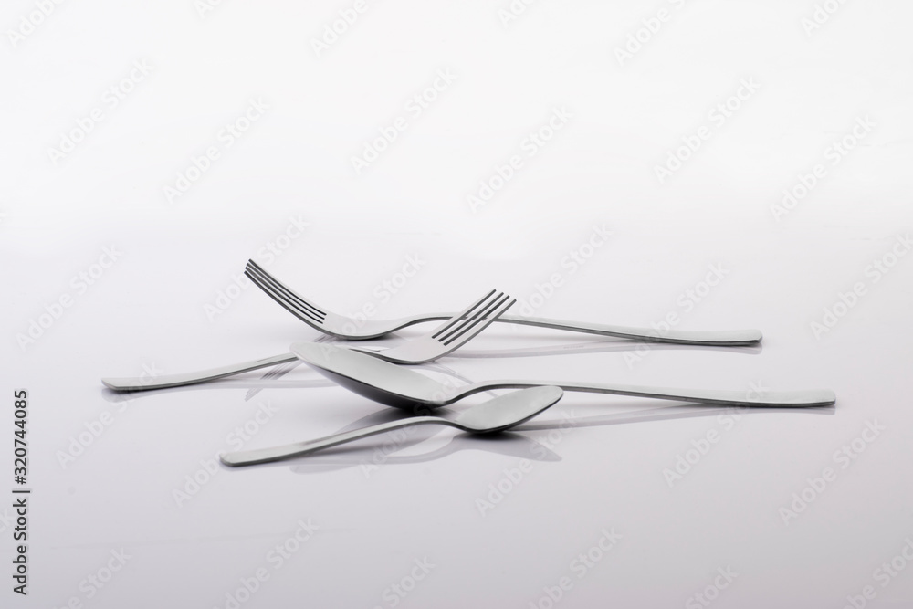 Utensils (forks and spoons) on a white background. Product photography. Utensils (forks and spoons) on a white background. Product photography.