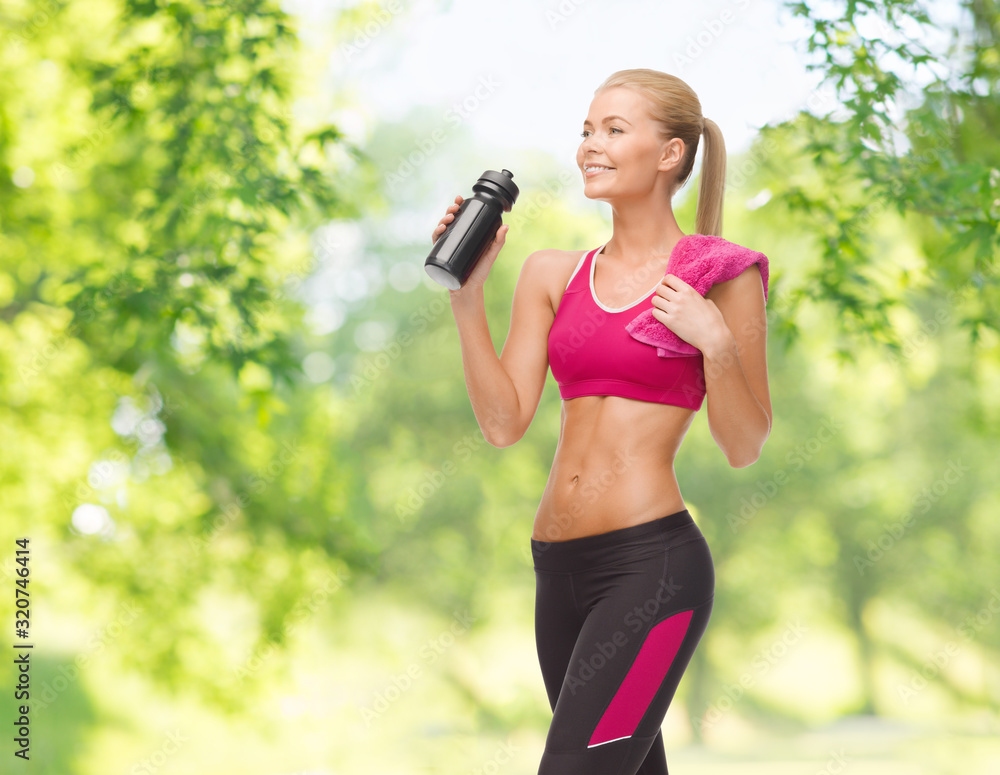 fitness, spot and people concept - happy smiling sporty woman drinking water from bottle over green natural background fitness, spot and people concept - happy smiling sporty woman drinking water from bottle over green natural background