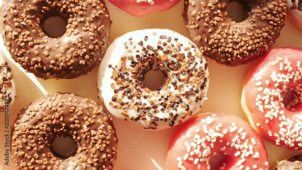 donuts, doughnuts rotating, turning round, view from above, flat lay