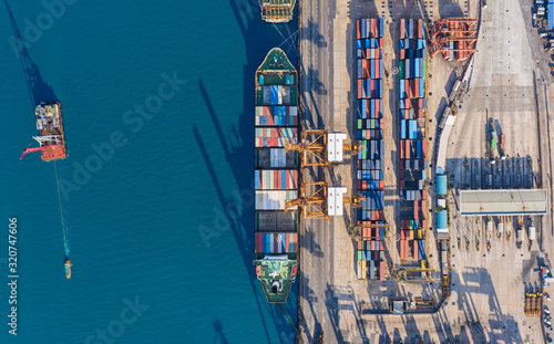 Aerial top view container cargo ship at terminal commercial port for business logistics, import export, shipping or transportation.