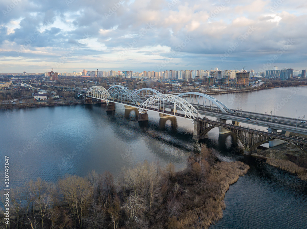 Aerial drone view. Darnitsky railway-automobile bridge in Kiev in the sunset light. Aerial drone view. Darnitsky railway-automobile bridge in Kiev in the sunset light.