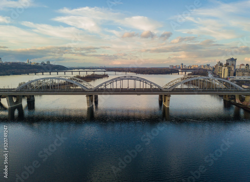Aerial drone view. Darnitsky railway-automobile bridge in Kiev in the sunset light. © Sergey
