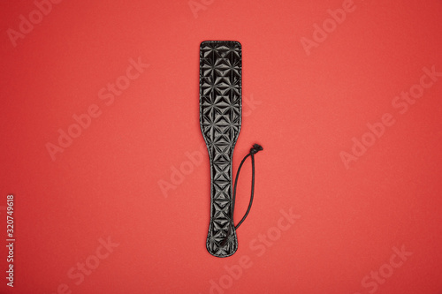 top view of leather paddle isolated on red