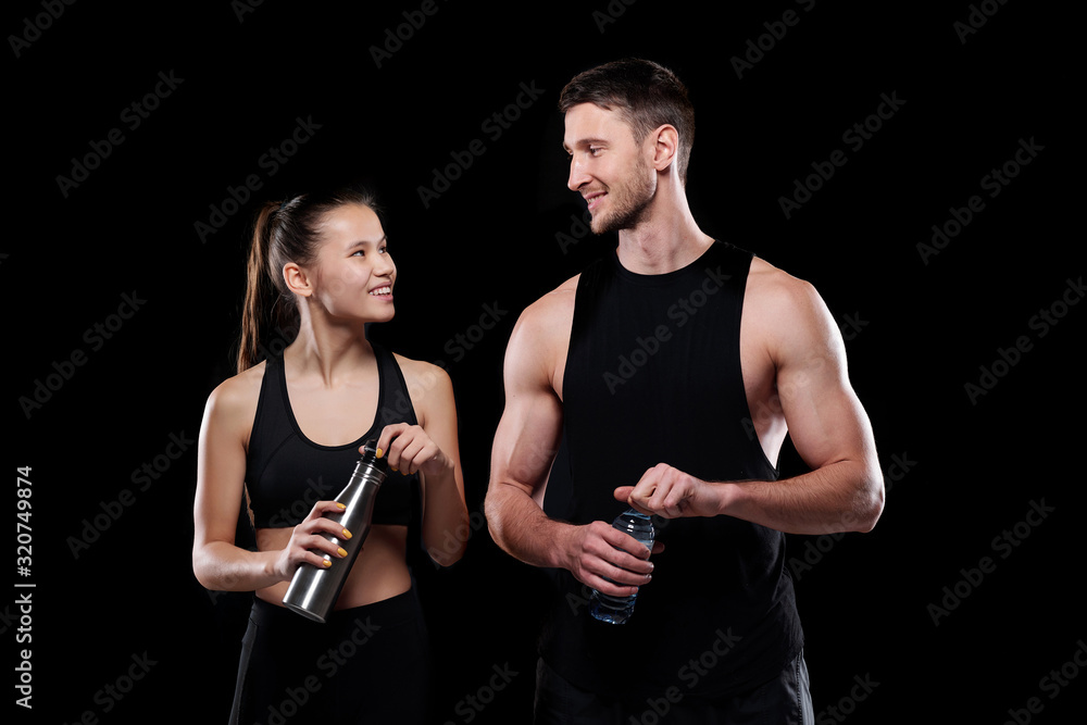 custom made wallpaper toronto digitalCheerful girl and sportsman with bottles of water looking at one another with smiles while going to drink after training