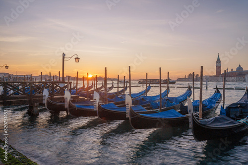 famous gondolas at sunrise. Venice, Italy. picture with long exposure © ver0nicka