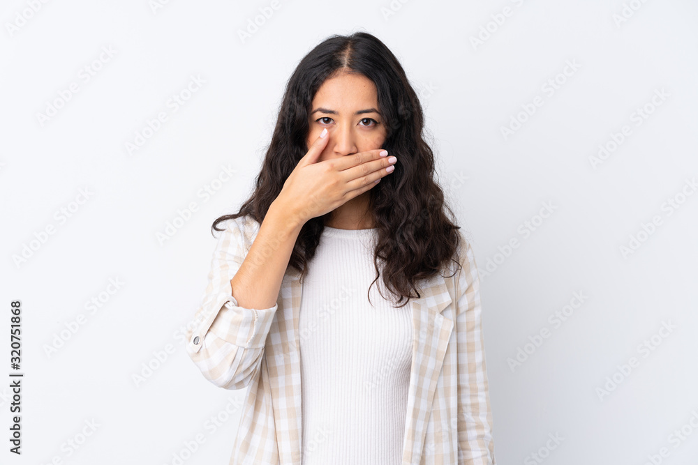 Mixed race woman over isolated white background covering mouth with hands Mixed race woman over isolated white background covering mouth with hands