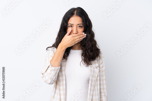 Mixed race woman over isolated white background covering mouth with hands © luismolinero