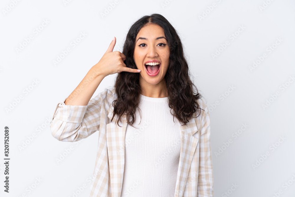 Mixed race woman over isolated white background making phone gesture. Call me back sign Mixed race woman over isolated white background making phone gesture. Call me back sign