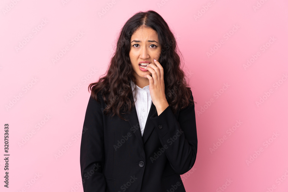 Mixed race business woman over isolated pink background nervous and scared Mixed race business woman over isolated pink background nervous and scared