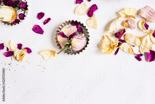 Flower arrangement of dried flowers. White buds and pink rose petals on a white background. Symbols of love for Happy Women, Mothers, Valentine's Day, greeting card template.