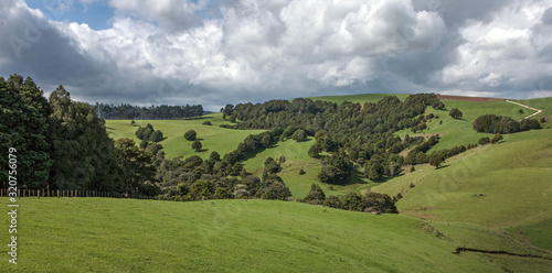 Kaipara New Zealand. Maitahi. Rain clouds. Hills and meadows