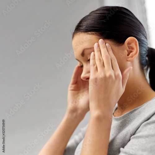 people, health, stress and problem concept - close up of unhappy woman having headache