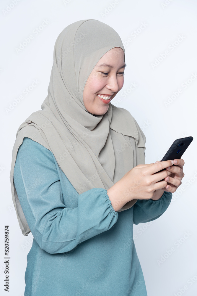 Muslim female using her mobile phone. Muslim female using her mobile phone.